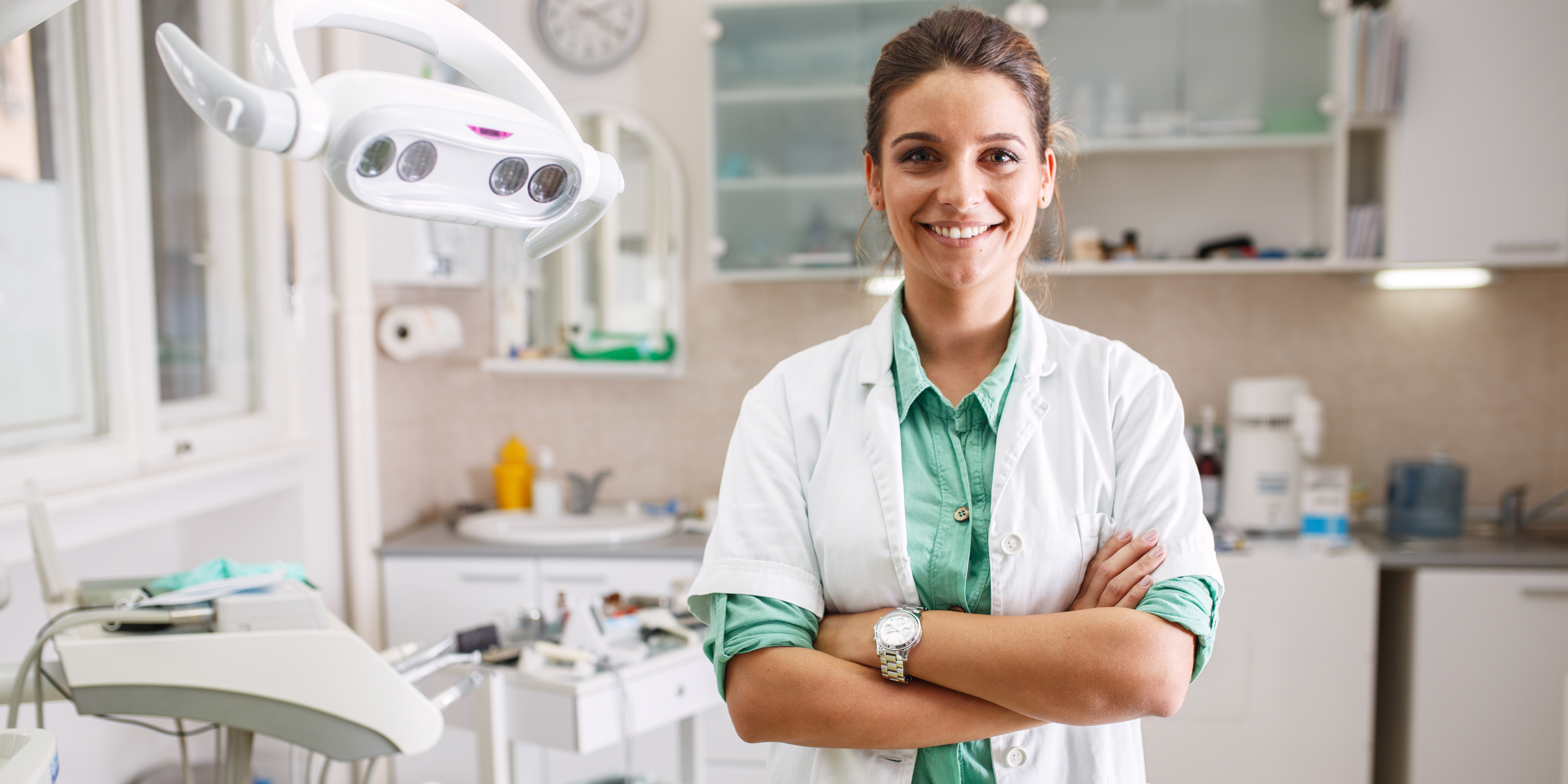 Dentist standing in front of equipment