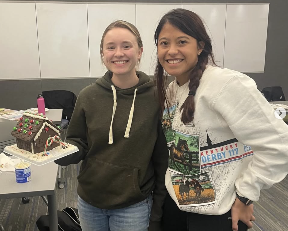 2 ABT Club members show off their gingerbread house
