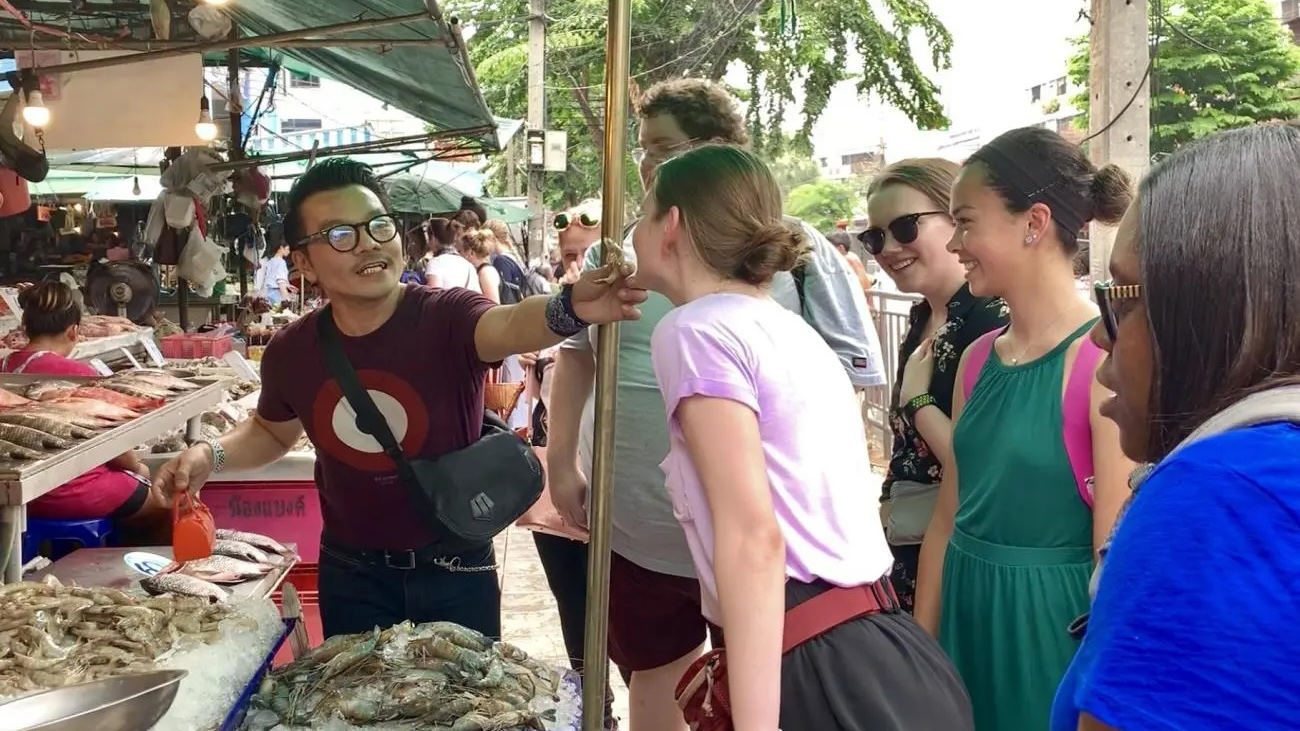 Students shop at a market abroad