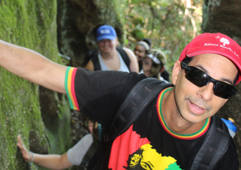 Michael Goodin hikes between rocks with students following
